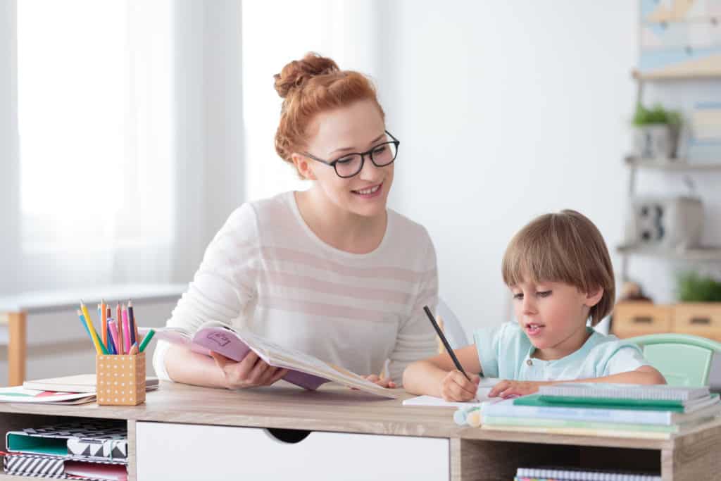 How To Teach An Autistic Child To Read 📚📖 1 Smiling mother helping son with homework